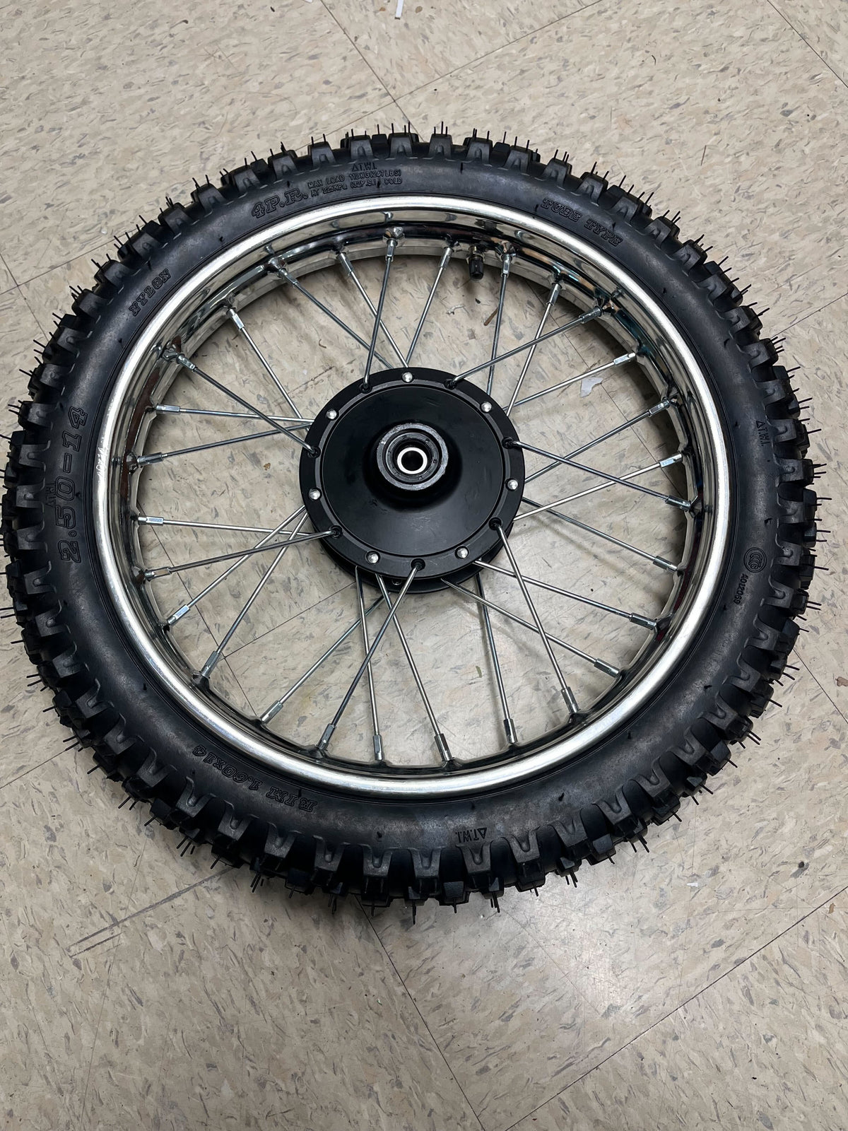 14 (2.50-14) Front Wheel Assembly for Dirt Bikes (Blemished) featuring a black tire with metal spokes and a knobby tread, including the front rim, inner tube, and wheel bearings.