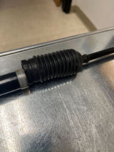 Steering Gear Assembly for Coleman KT196 196cc 6.5 Hp Go-Kart (Blemished) on a metal surface, featuring a black rubber tube, cables, and tools.