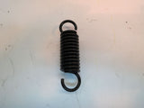 Caster Arm Spring for the Jazzy 614 and 614HD (Used); a close-up of a black coil spring on a white surface, part of the front caster assembly for power chairs.