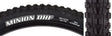 Close-up of a 26x2.5 Minion DHF Bicycle Tire, showcasing its ramped knobs and channel-cut knobs designed for low rolling resistance and improved gripping edges, ideal for downhill riding.