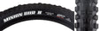 Close-up of a 27.5x2.4 Minion DHR II ST/2PLY Bicycle Tire, highlighting its ramped knobs for low rolling resistance and channel-cut knobs for enhanced grip and cornering.
