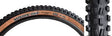 Close-up of the 27.5x2.5 Minion DHF EXO/TR/WT Bicycle Tire, showcasing its ramped knobs for low rolling resistance and channel-cut knobs for enhanced grip and control.