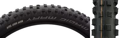 Close-up of a 29x2.6 Magic Mary Evolution SnakeSkin Bicycle Tire, showcasing its square block center tread, large corner knobs, and reinforced sidewalls, designed for traction in wet and muddy conditions.
