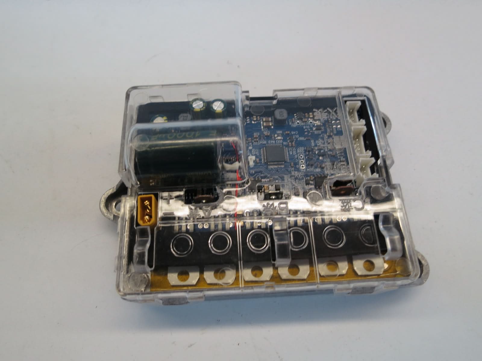 Bluetooth Board, Motherboard, & Harness for Xiaomi Mi M365, shown inside a transparent plastic box with visible circuit board and wiring, crucial for the scooter's console and battery tray operations.