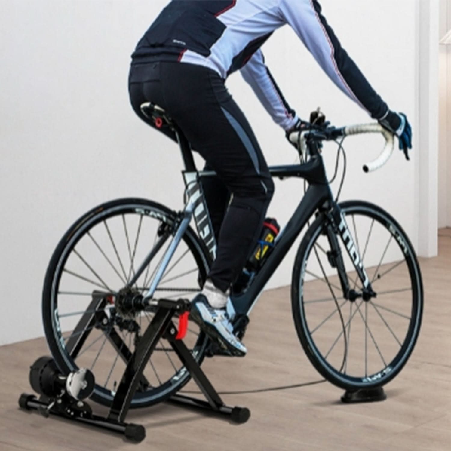 Bicycle Trainer Riser Block for Bike Front Wheels: Image shows a person riding a bike with a close-up of the front wheel on a stable riser block, ideal for leveling during training.