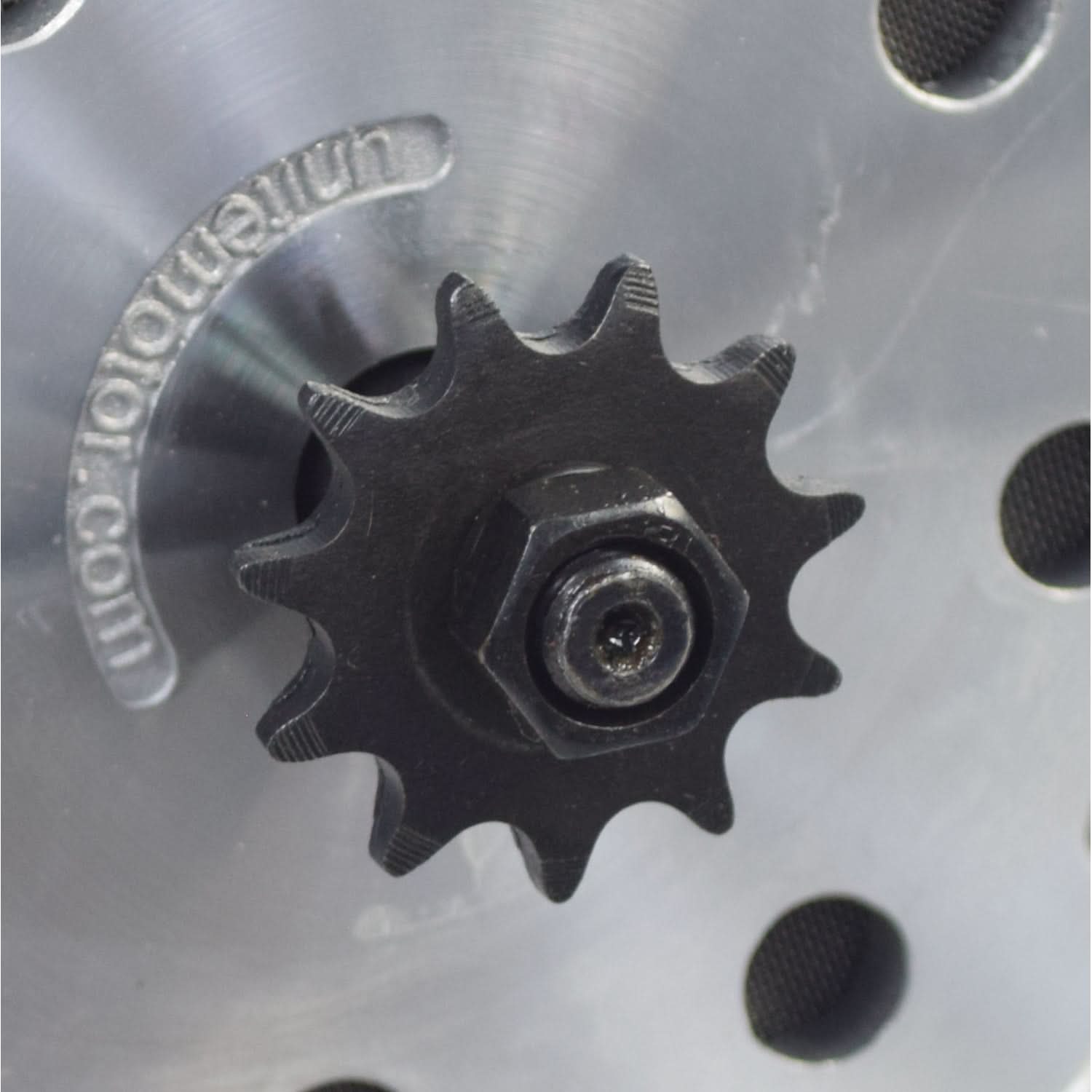 24 Volt 500 Watt MY1020 Electric Motor with 11 Tooth #25 Chain Sprocket (Blemished), showing a black gear on a metal surface, including visible mounting holes and a nut.