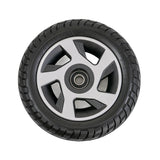 9 Front Wheel Assembly for the Pride Mobility Zero Turn 10 (S710ZT) Scooter featuring a solid, flat-free black tire with a silver rim and pre-installed bearings.