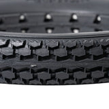 Close-up of the 12-1/2x2-1/4 Dark Gray Solid Urethane Mobility Tire with Knobby Tread, highlighting its robust, flat-free design suitable for both indoor and outdoor use.