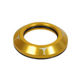 Titen Headset Dust Cover Cap for Kick Scooters, a gold circular object featuring a white logo, designed to protect your scooter's head bearings from dirt and moisture, made of lightweight anodized alloy.