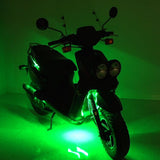 Multi-Color LED Light Kit for Street Scooters, shown illuminating a scooter with green lights, highlighting its vibrant, customizable glow for enhanced visibility and style.