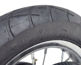Close-up of the Rear Wheel Assembly with Wire Spoke Rim for the Razor Pocket Mod (Versions 13-30), showcasing the tire tread, wire spokes, and part of the rim.