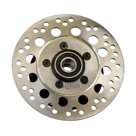 Hub & Disc Assembly for the Pride Pursuit XL (SC714) mobility scooter, featuring a circular metal object with holes, designed to hold the front wheels with 13x4 black low profile tires.