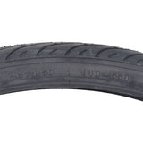 26x1.5 Black Flat Shield MTN Bicycle Tire from Sunlite, featuring a detailed tread pattern for mountain biking. This close-up highlights the robust rubber material and precise craftsmanship.