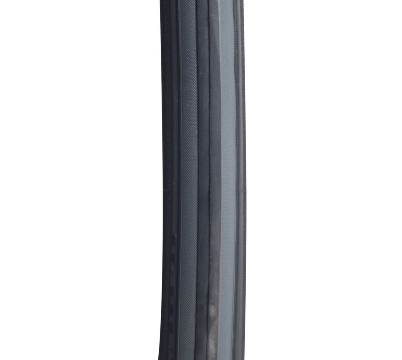 Close-up of 700x25 Czar Wire Bicycle Tire, showcasing its grooved lateral tread for traction and smooth center, designed with Dual Compound for durability and Exceptional Puncture Safety layer for protection.