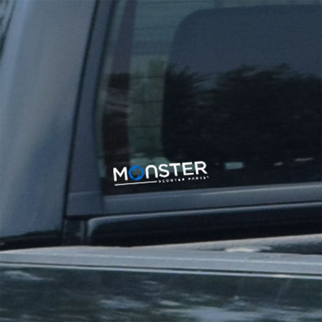 Monster Scooter Parts 6 Window Decal on a car window, featuring a close-up of the white logo sticker displaying the company's name.