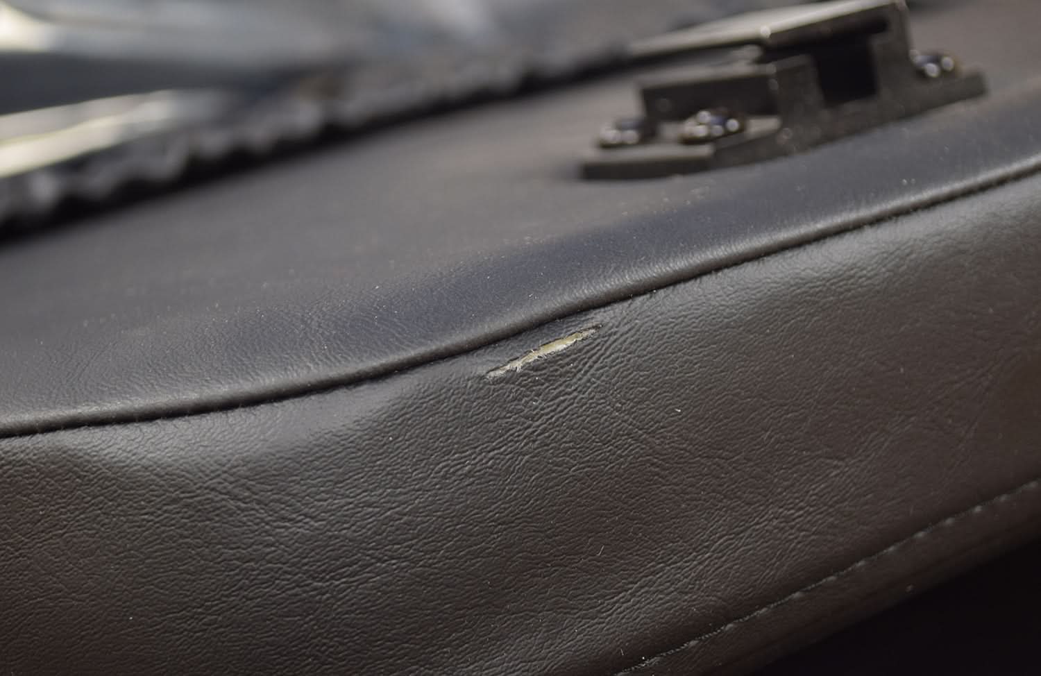 Close up of the 18x18 High Back Black Vinyl Limited Recline Seat Assembly for the Jazzy 1100, showcasing the black leather texture and stitching details.