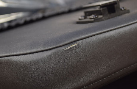 Close up of the 18x18 High Back Black Vinyl Limited Recline Seat Assembly for the Jazzy 1100, showcasing the black leather texture and stitching details.