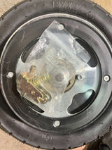 Rear Wheel Assembly with Wire Spoke Rim for the Razor Pocket Mod (Versions 13-30) (Blemished) showing wheel with plastic bag and metal spring on top, close-up of screws.