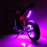 Multi-Color LED Light Kit for Razor Electric Bikes & Scooters, featuring purple lights illuminating a motorcycle's wheels, kickstand, and seat, creating a vibrant, glowing effect.