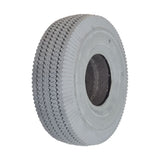 Close-up of the 4.10/3.50-4 Foam-Filled Mobility Tire with C189 Sawtooth Tread, showcasing its detailed synthetic rubber texture and central hole, designed for mobility scooters and power wheelchairs.