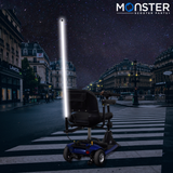 48 Multicolor LED Whip Light & Utility Cart Hitch Extender Kit for Mobility Scooters: a scooter with a vibrant LED pole light attached to a hitch extender, illuminating the street.