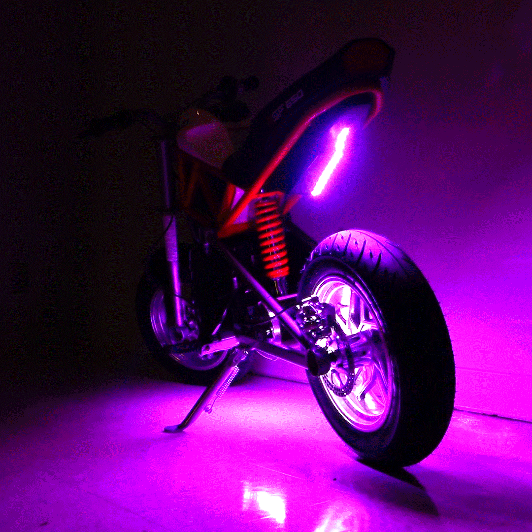 Multi-Color LED Light Kit for Razor Electric Bikes & Scooters, featuring a motorcycle with vibrant purple lights on the wheels and kickstand, enhancing visibility and style for night rides.