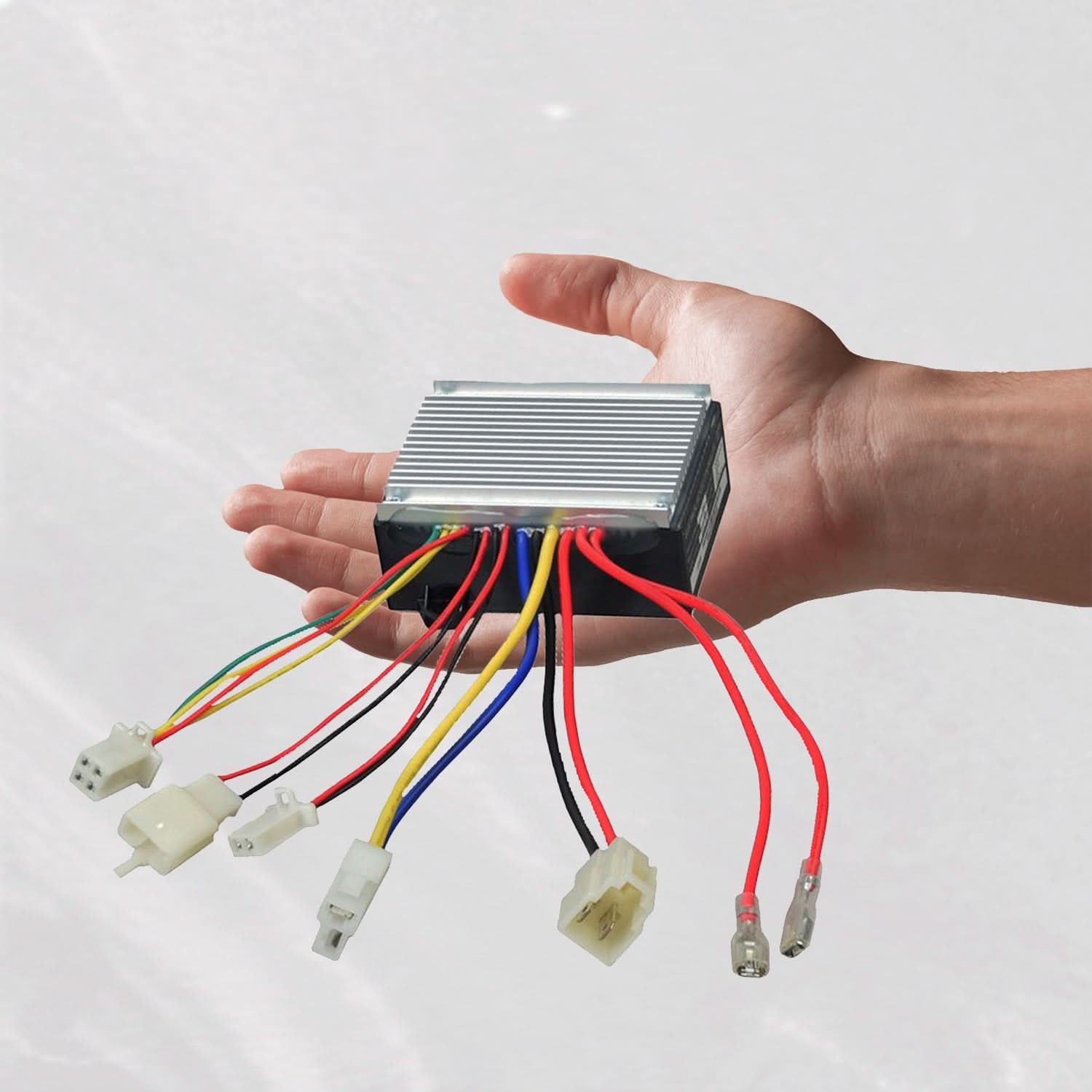 Hand holding ZK2430HB-FS Throttle & Control Module Bundle for Razor E300, Versions 11 and 13-19, showing wires and connectors for scooter compatibility.